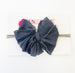 Classic ruffle bow on a nylon headband.