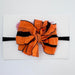 Classic ruffle bow on a nylon headband.