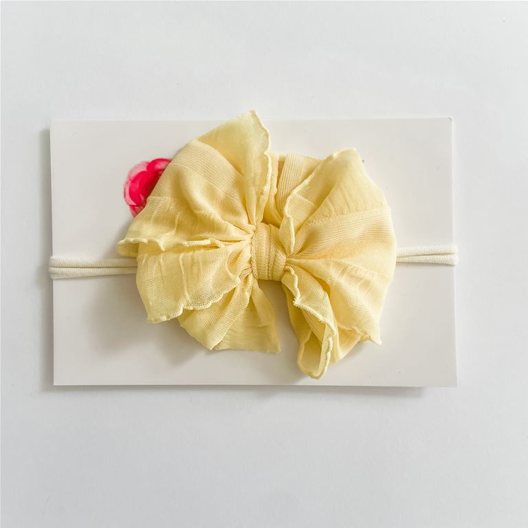 Classic ruffle bow on a nylon headband.